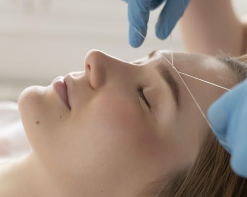 close-up-young-woman-getting-eyebrow-treatment