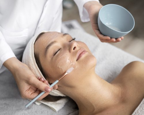 high-angle-woman-getting-massaged-spa